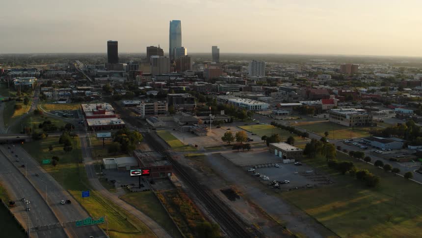 An aerial view of green lawns and a city landscape