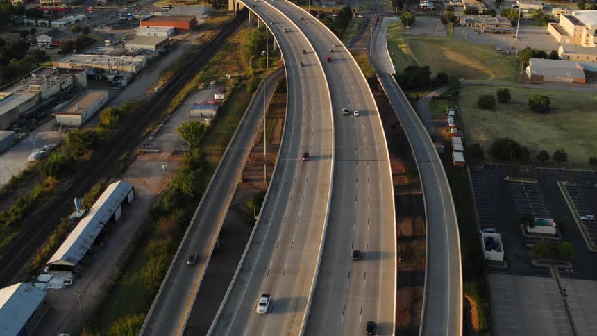 Vehicles down down a multilane highway through a suburb