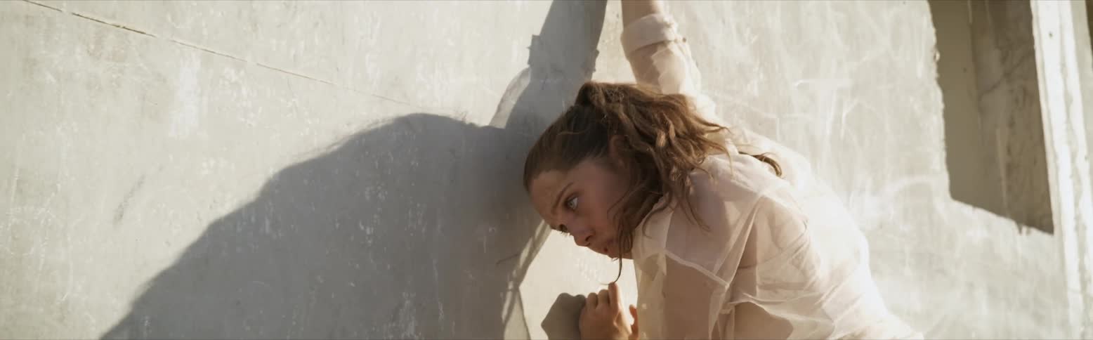A woman doing something to a wall