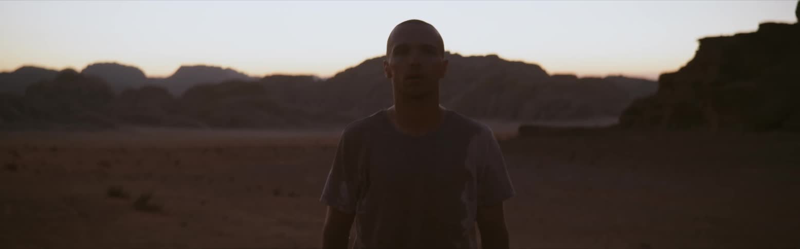 Two people moving erratically and dancing in the desert