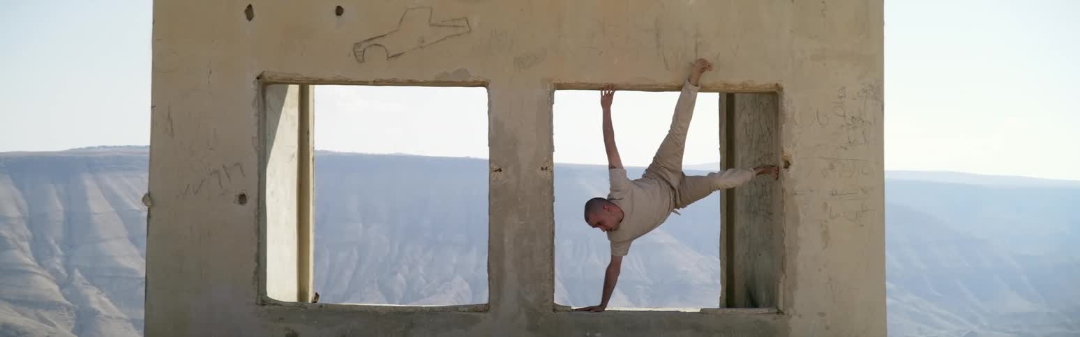 A man stretched out in a window frame