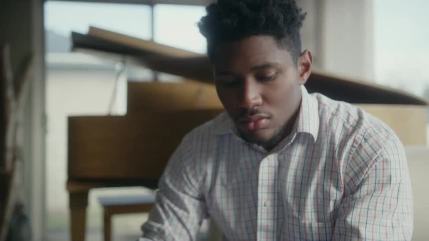 A worried man concentrates at home