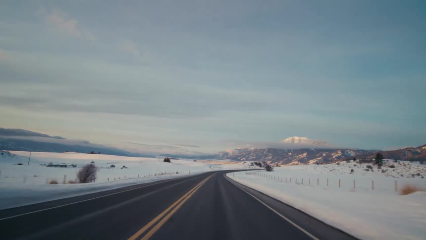 The road is surrounded by snow