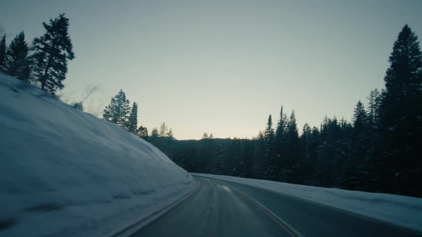 An empty road during winter is displayed