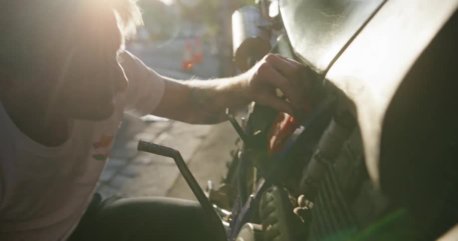 A man is repairing his motorcycle