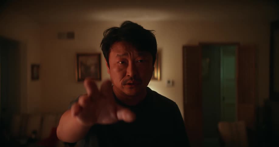 Man moves forward reaching out a trembling hand with an upset expression
