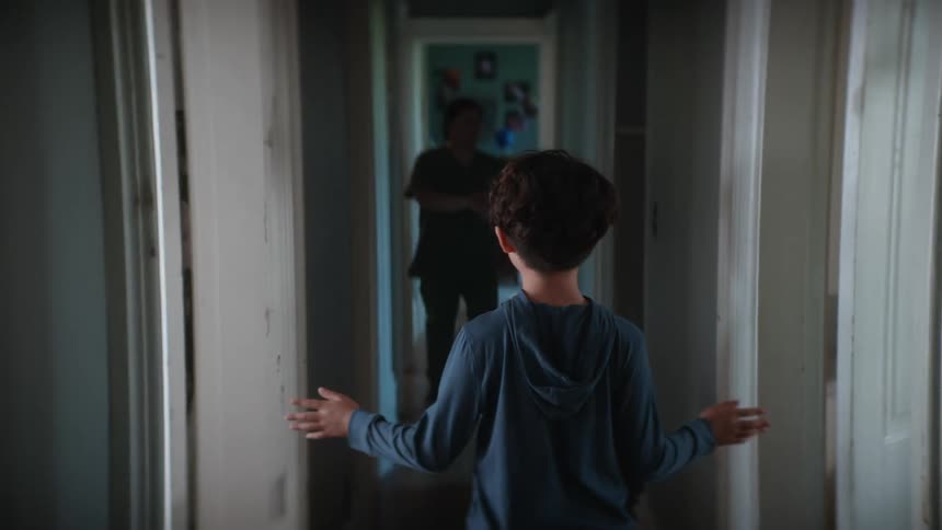 A boy walks down the hallway