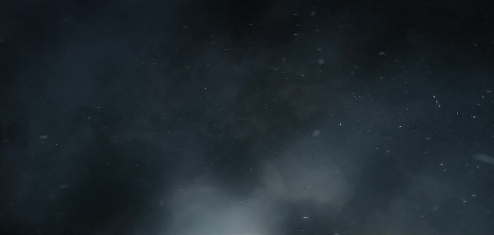 Moving through space as stars shine and asteroids fly among fog in the darkness