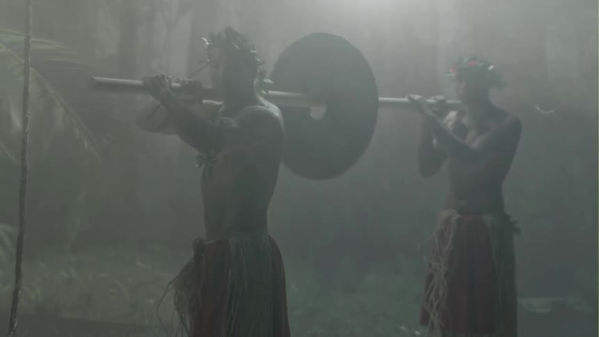 Two tribesman are holding a pole together