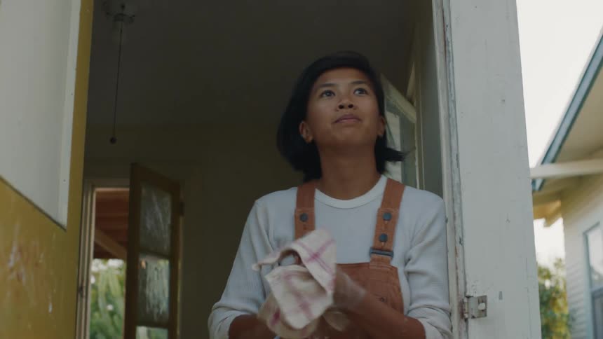 A woman sculpting and wiping off her hands