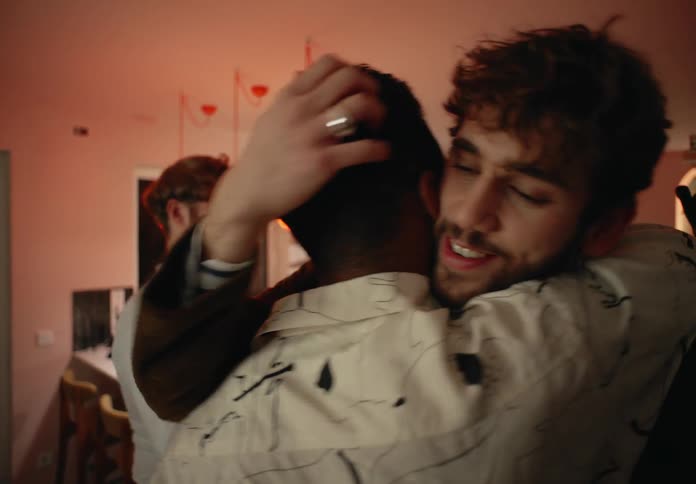Four young people saying good night to each other hugging and smiling