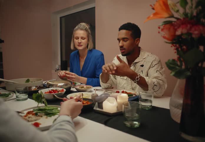 Friends sit at dinner party talking