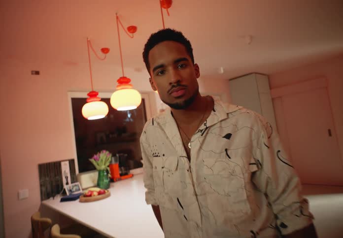 A man standing near the counter as the camera zooms in on his face