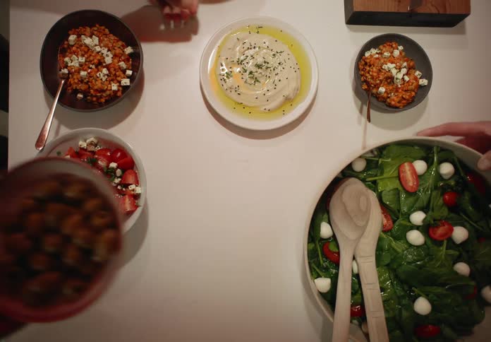 People prepare different dishes for dinner