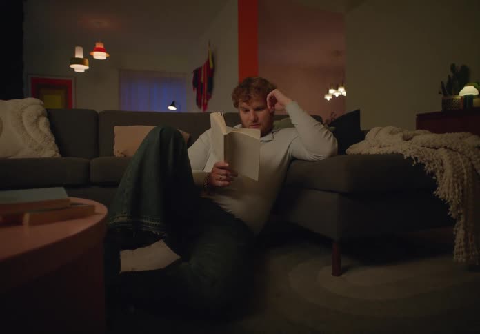 A man reading a book in a room