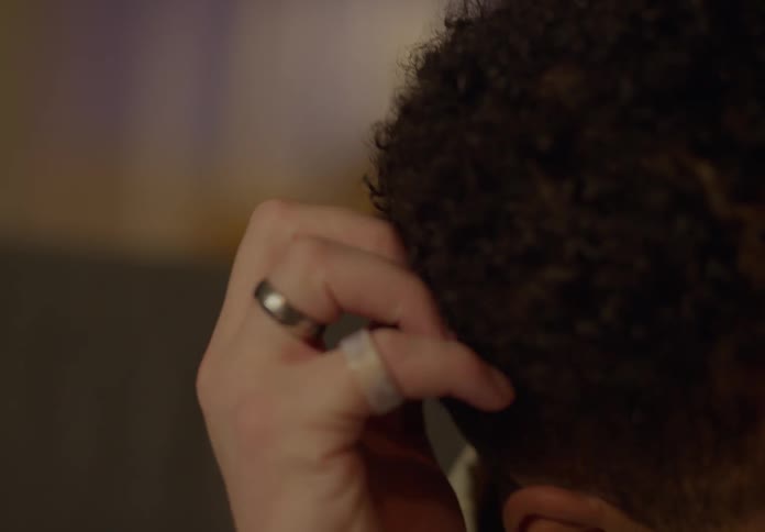 Man strokes and touches mans hair