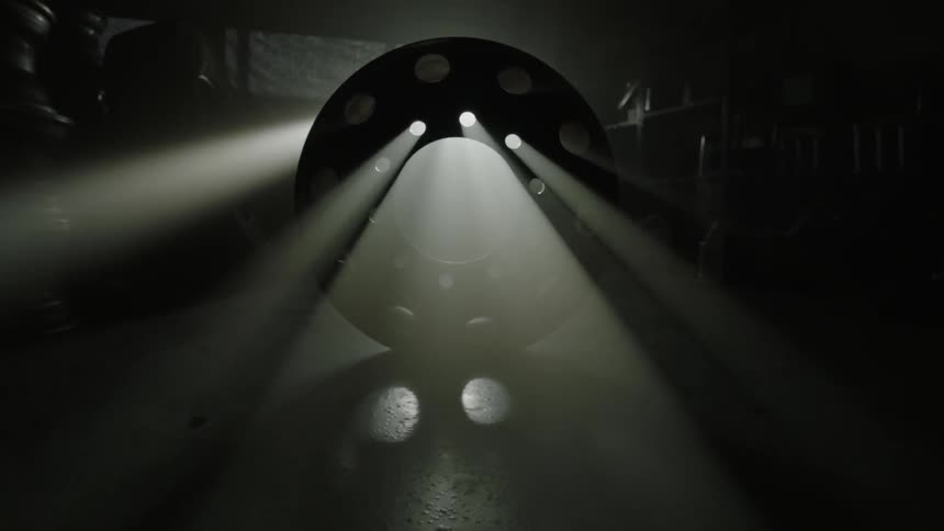 Light shines through a tire in a dark room