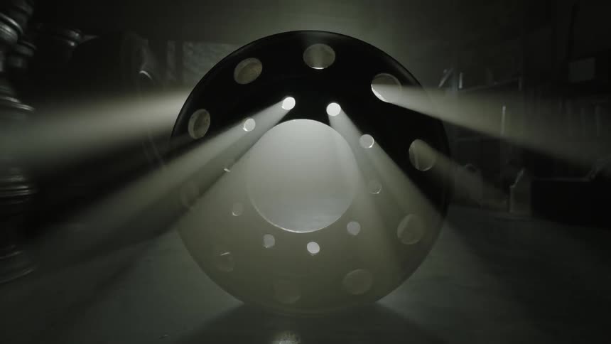 A hub cap rolls across the floor
