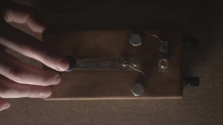 Finger repeatedly presses a metal lever