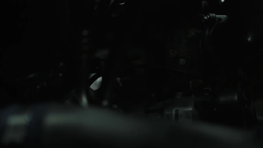 A hose is in a dark engine