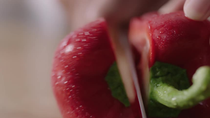 A pepper is cut with a knife