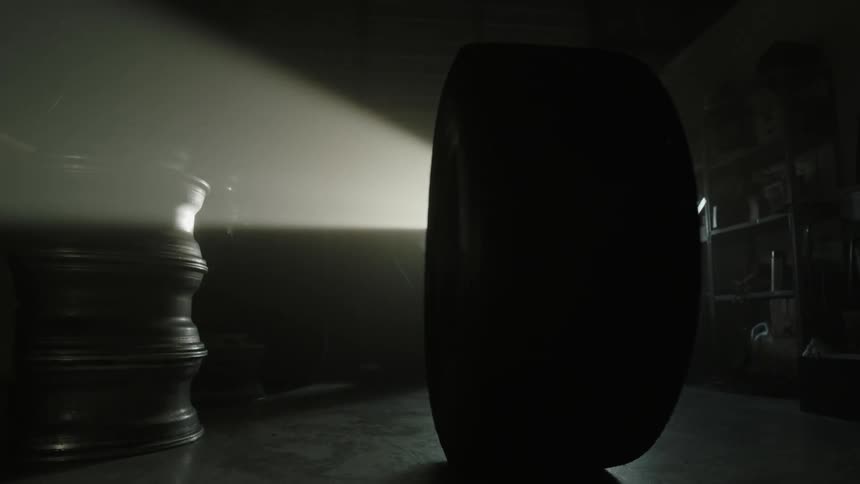 An automotive wheel rotates by itself in a garage