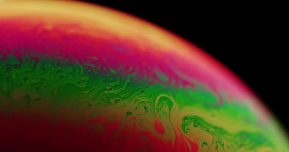 Bright colored paints combine and swirl together