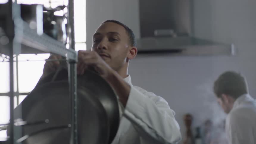 Chefs prepare food in a kitchen
