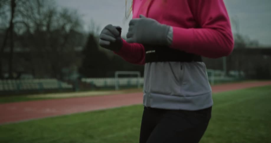 A woman is jogging outdoors during the spring time