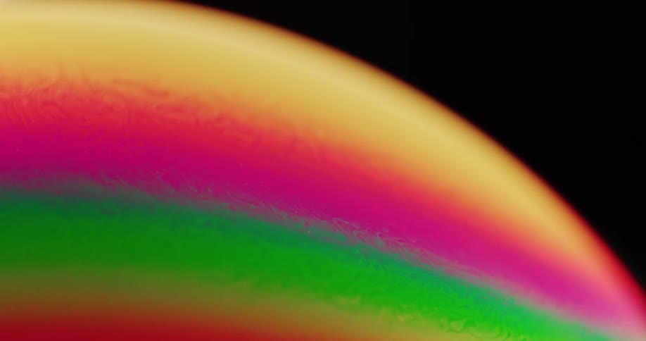A moon is shown moving slowly through the sky with a rainbowlike color