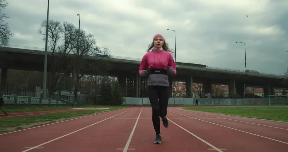 A woman is running on the track