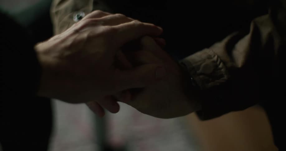A person holds another persons shaking hands