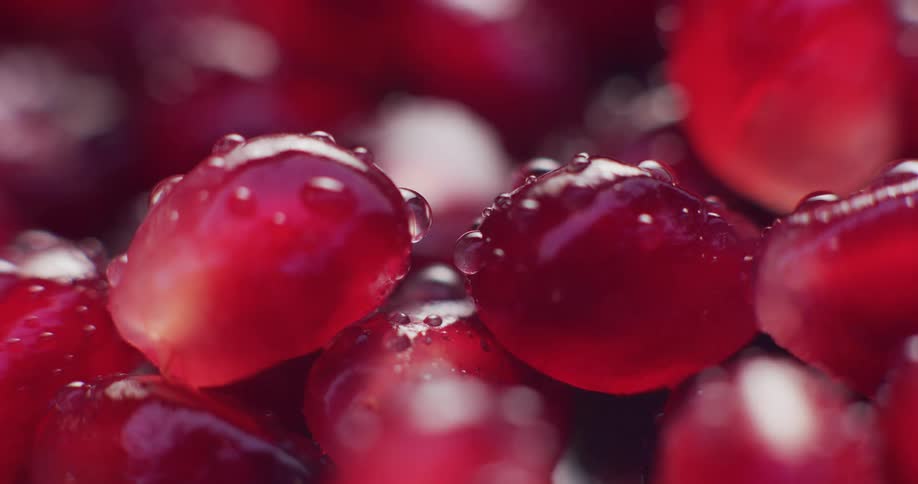 Ecu small cluster of pomegranate seeds beauty shot with condensation and light changes