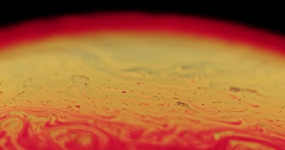 Red streaks move and blend into the yellow sphere glowing red as the surface moves