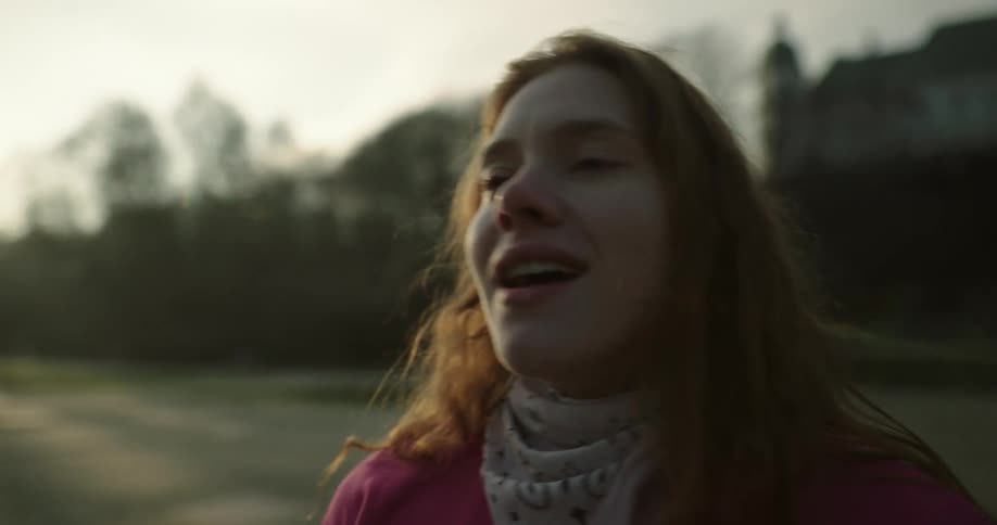 A woman dancing before looking at the camera