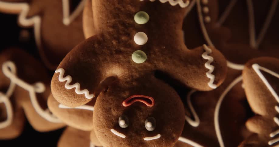 Gingerbread man cookie lying on top of other cookies