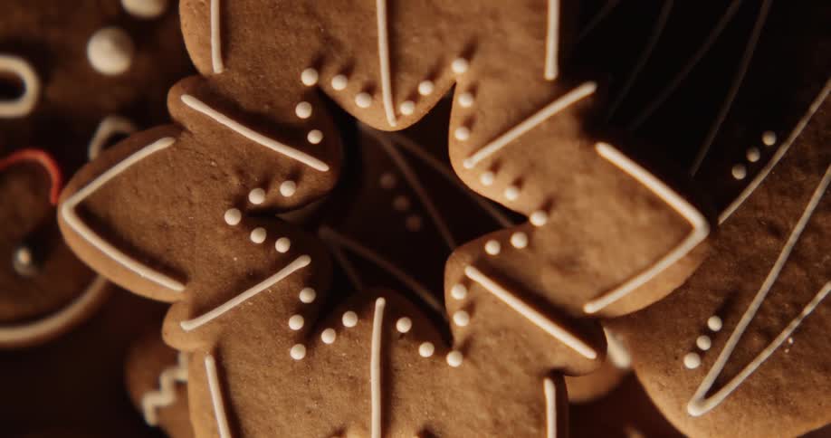 Icing decorates holiday gingerbread cookies as they sit on a plate