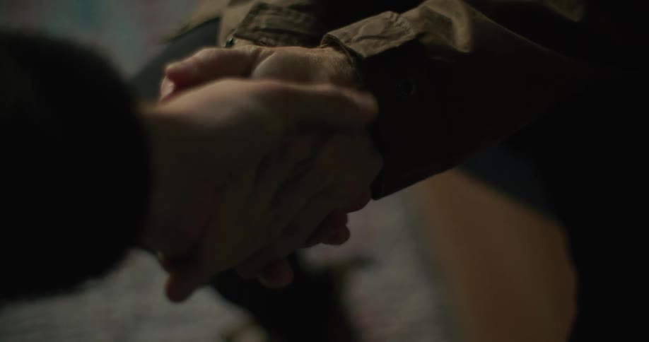 Two friends are shaking hands and being caring