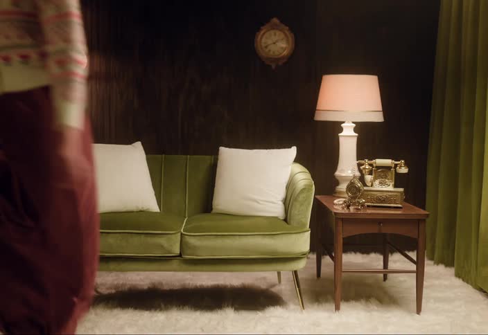A woman is sitting on a couch in her living room