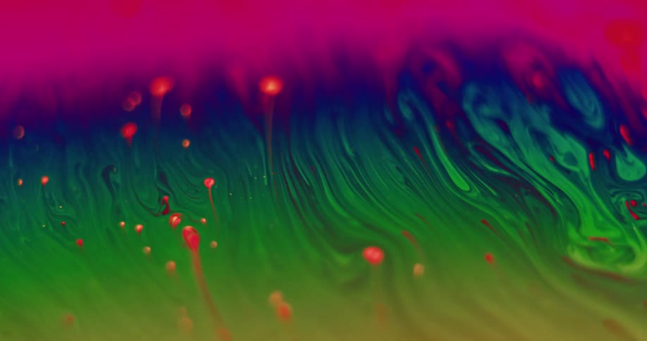 Bold bright paint colors of green blue and red mixing together