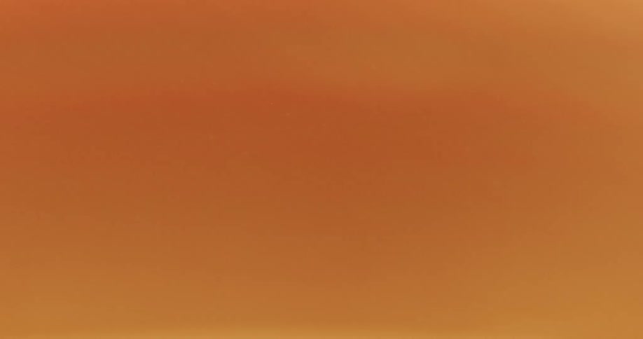 A bright red strip is moving down over a green stripe and yellow is filling in at the top until it turns orange and red