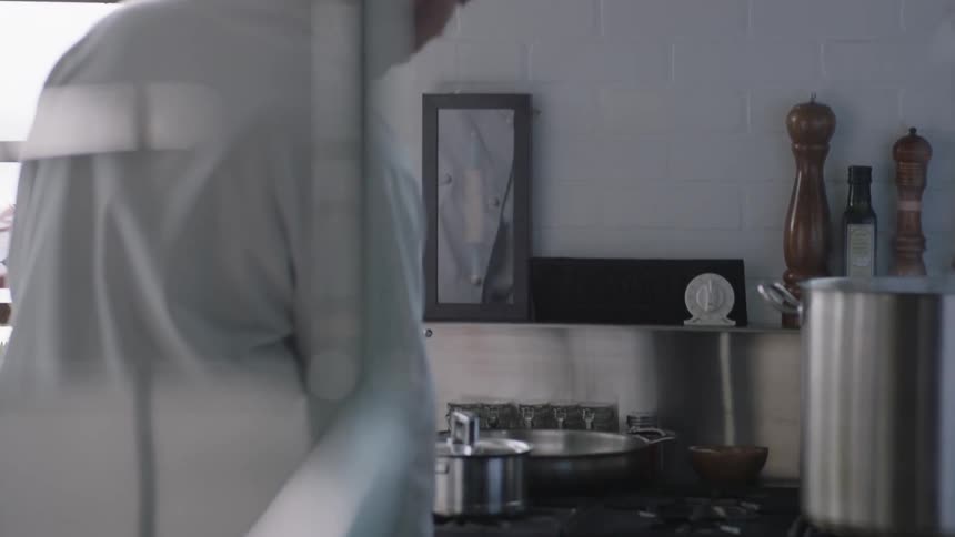 A chef is cooking in a kitchen