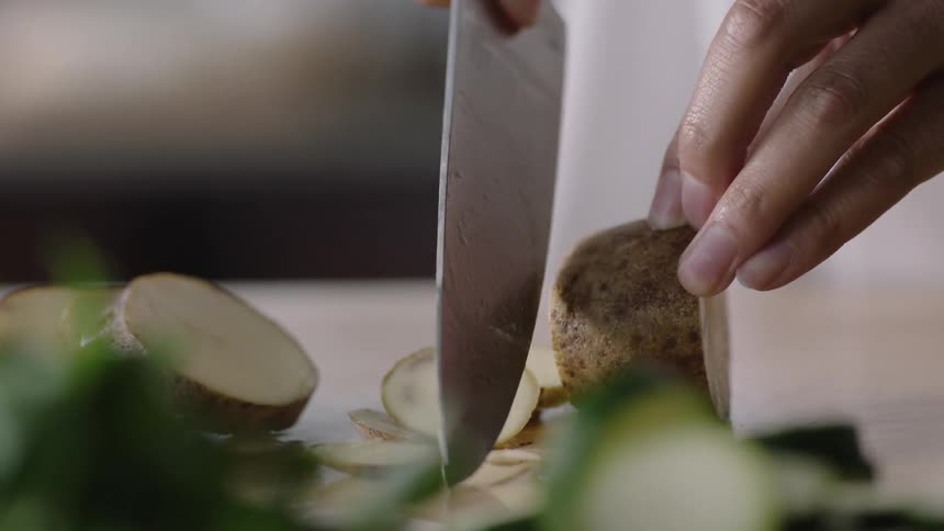 A chef is cutting potatoes