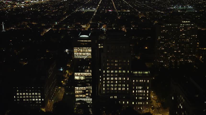 A nighttime aerial view of Independence Hall in Philadelphia Pennsylvania approached after flying over the citys downtown and historic landmarks