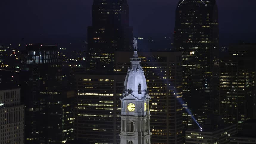 Aerial footage captures the iconic William Penn statue atop Philadelphia City Hall at night