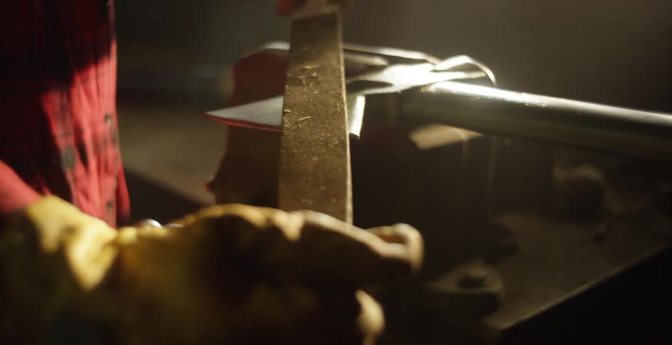 A person is sharpening an ax