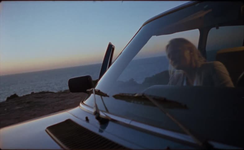 A woman getting into a car