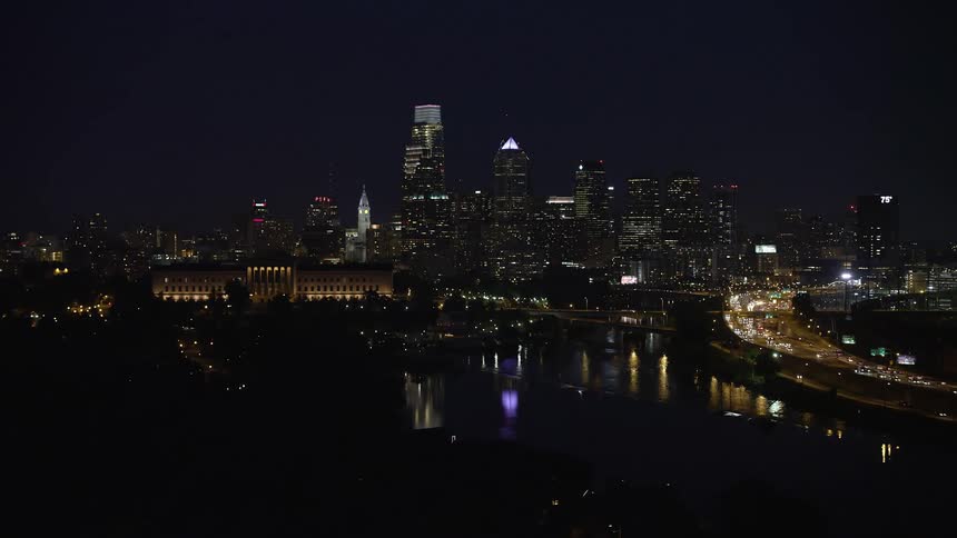 A nighttime aerial view of Downtown Philadelphia featuring the Philadelphia Museum of Art and the Schuylkill River