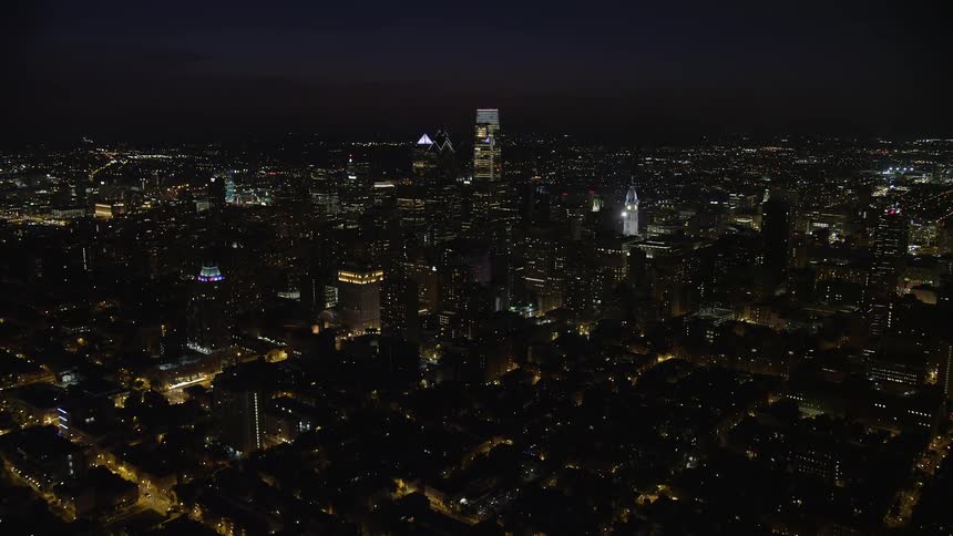 A stunning aerial view of Philadelphias downtown skyline with towering skyscrapers and clear skies at night