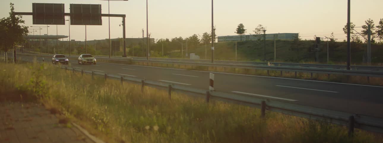 Vehicles drive down a four lane divided highway